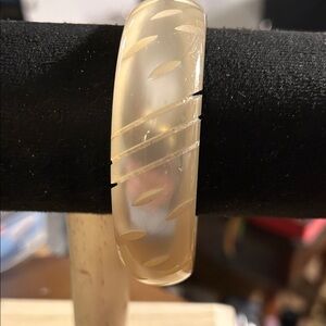 vintage carved lucite bangle bracelet with a satin finish.